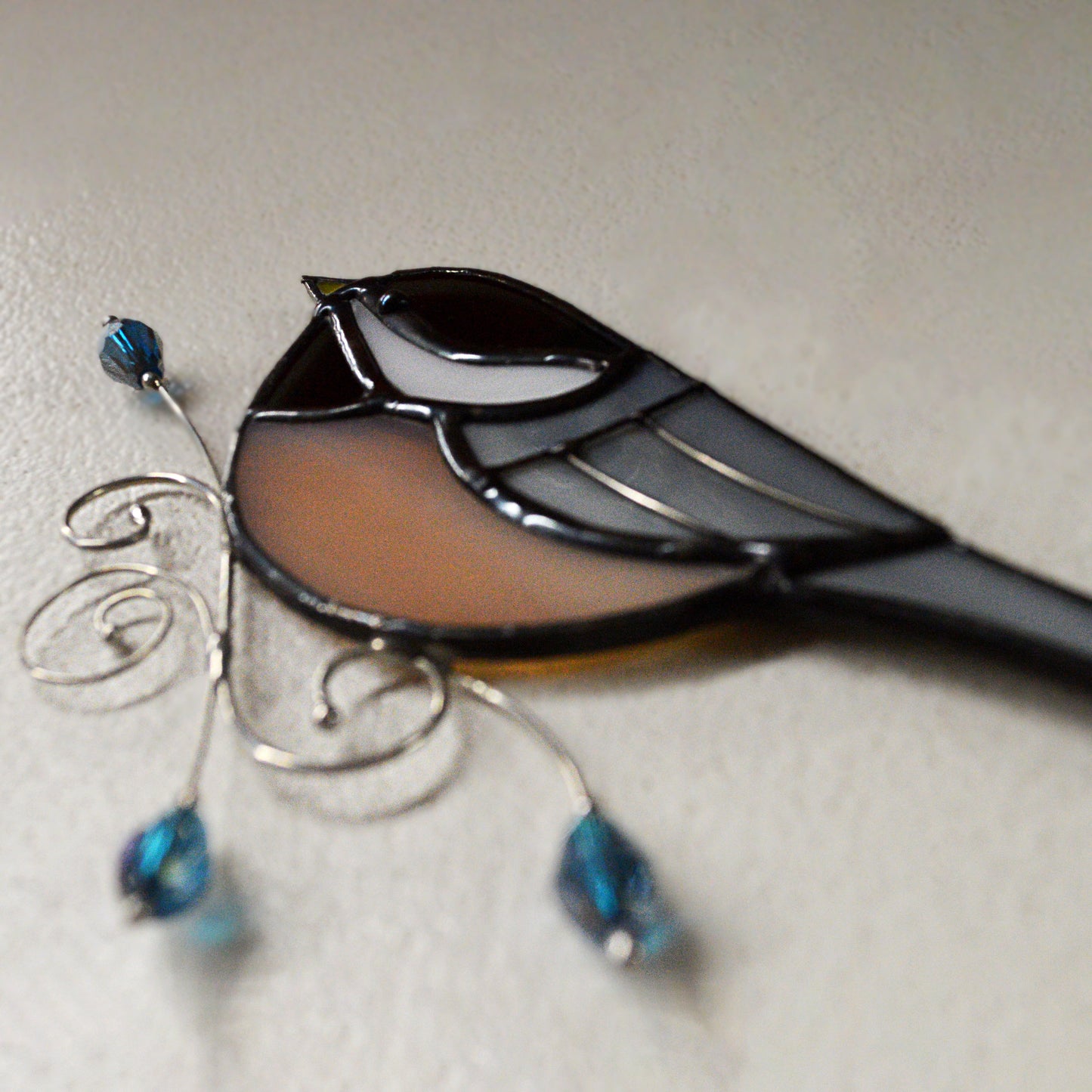This adorable chickadee stained glass suncatcher is a great for window decoration, as a gift and more! Hang it up in your window to see the full beauty of the stained glass, add it to a floral arraignment, or use it as a gift for the nature lover in your life. All stained glass is handmade by Deb's Broken glass in Bathurst NB.