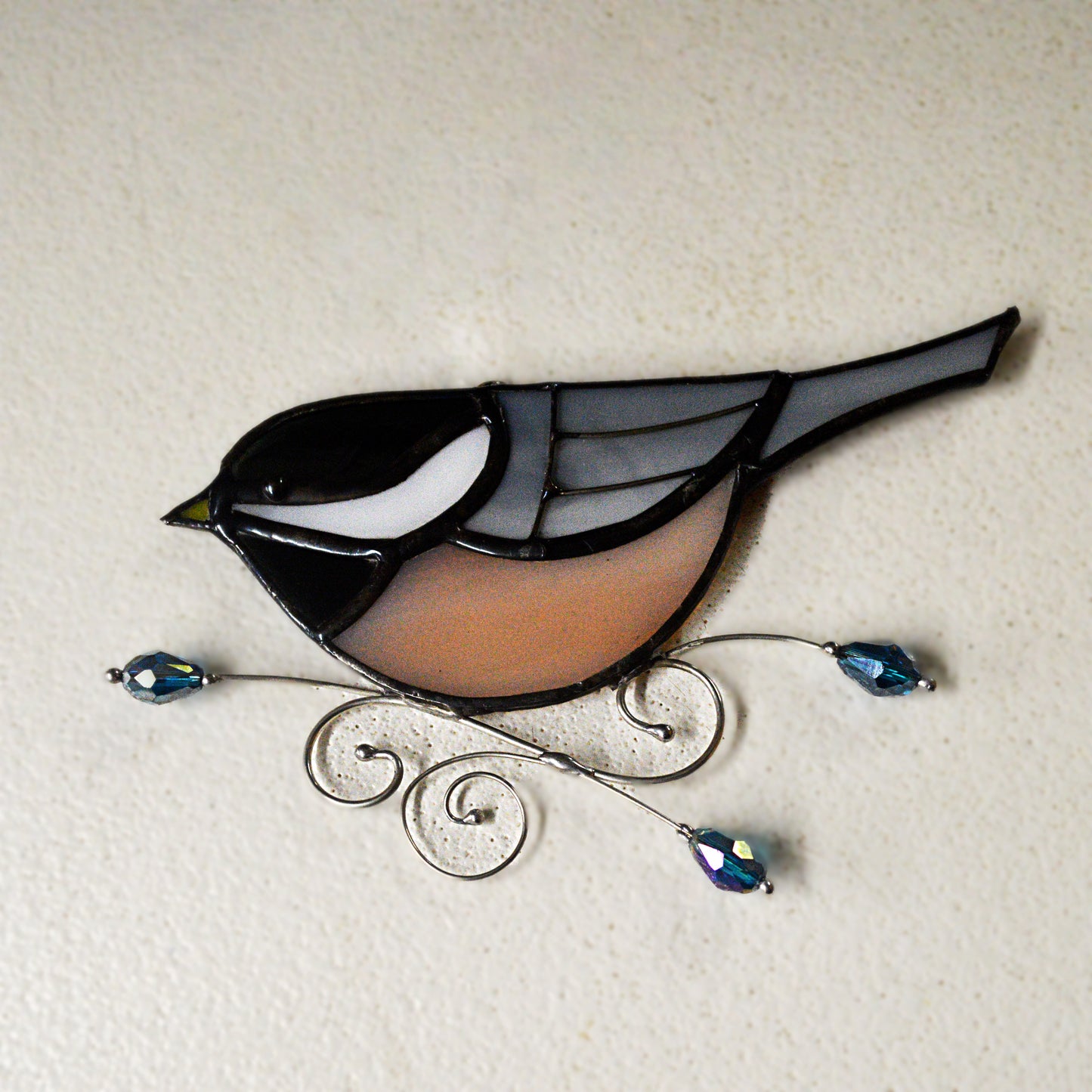This adorable chickadee stained glass suncatcher is a great for window decoration, as a gift and more! Hang it up in your window to see the full beauty of the stained glass, add it to a floral arraignment, or use it as a gift for the nature lover in your life. All stained glass is handmade by Deb's Broken glass in Bathurst NB.