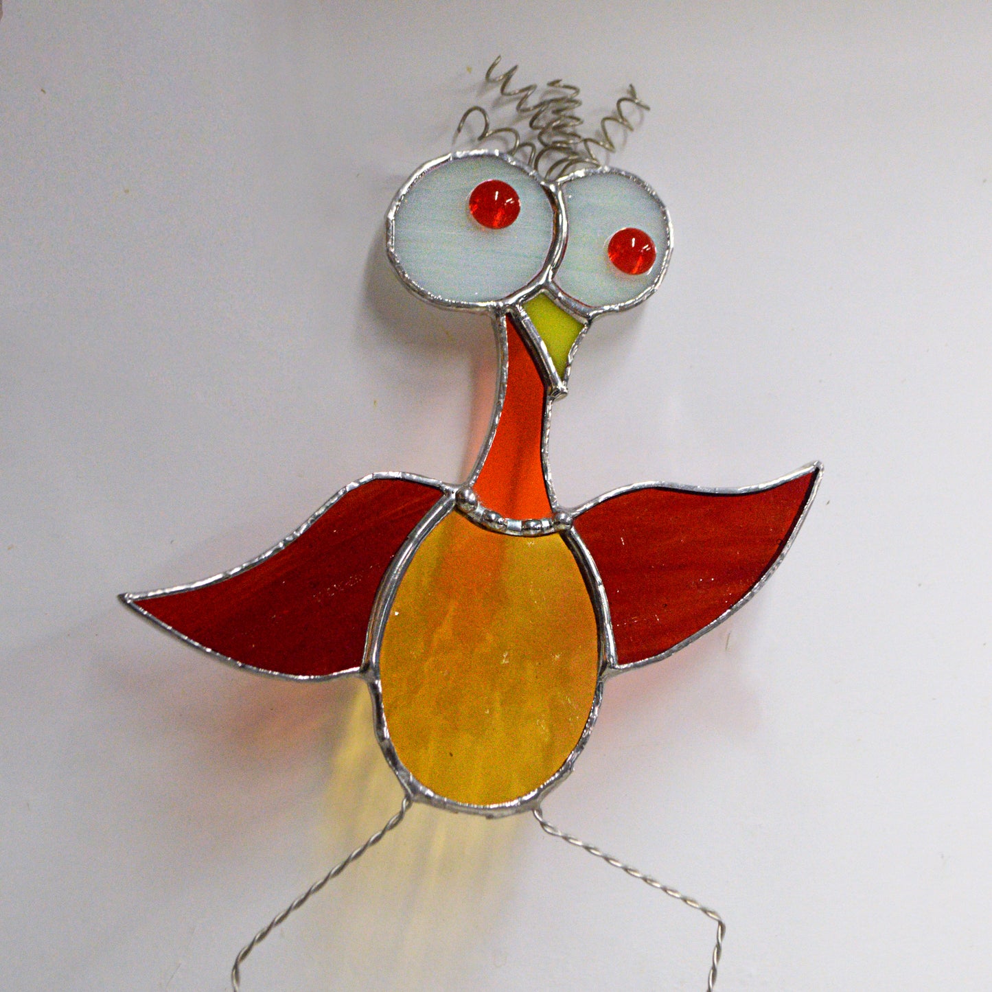 This adorable cartoon bird stained glass suncatcher is a great for window decoration, as a gift and more! Hang it up in your window to see the full beauty of the stained glass, add it to a floral arraignment, or use it as a gift for the nature lover in your life.   All stained glass is handmade by Deb's Broken glass in Bathurst NB